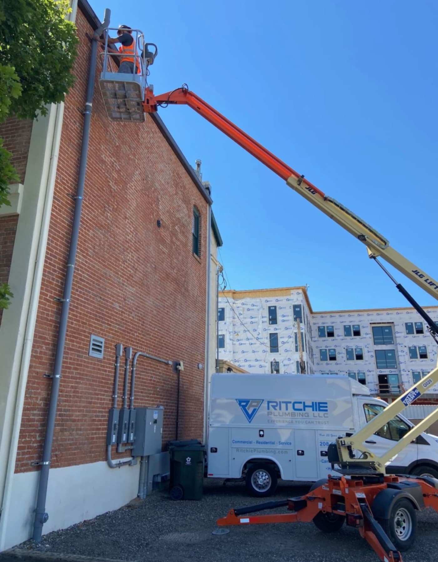 Ritchie Plumbing technician servicing plumbing on a commercial building, the kind of mixed-use work common in Garden City