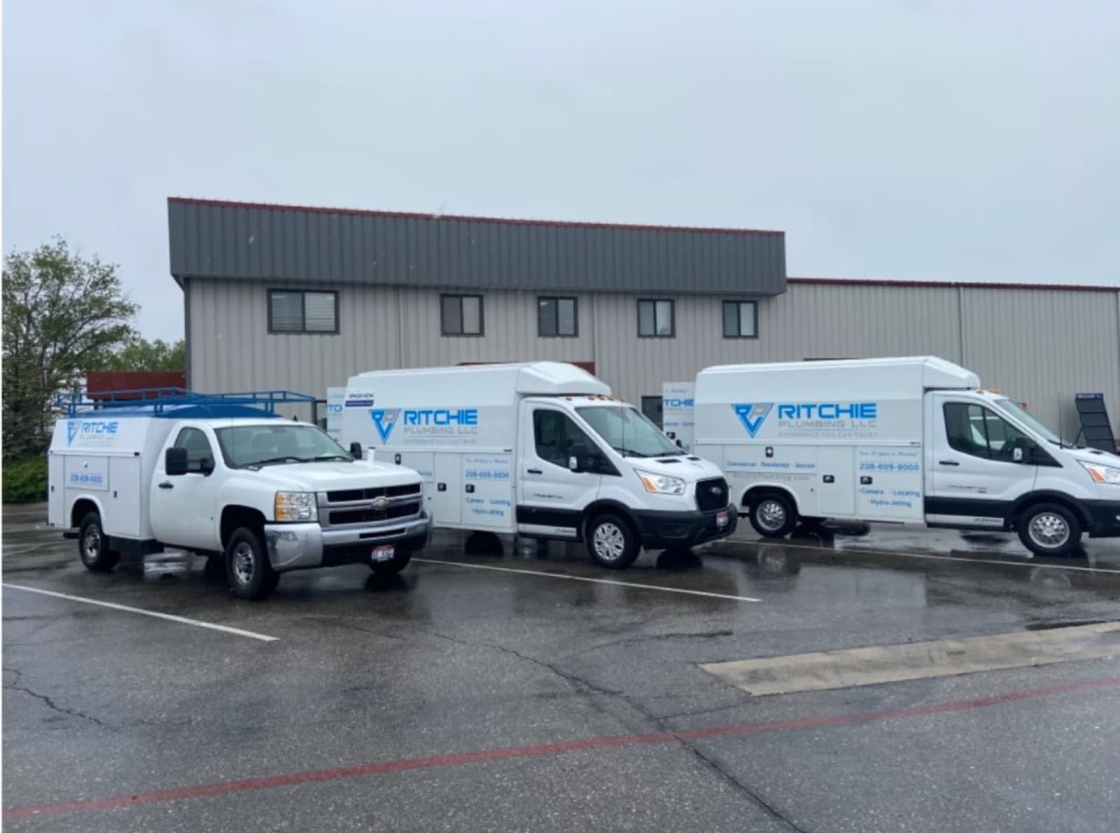 The Ritchie Plumbing truck fleet parked at the shop